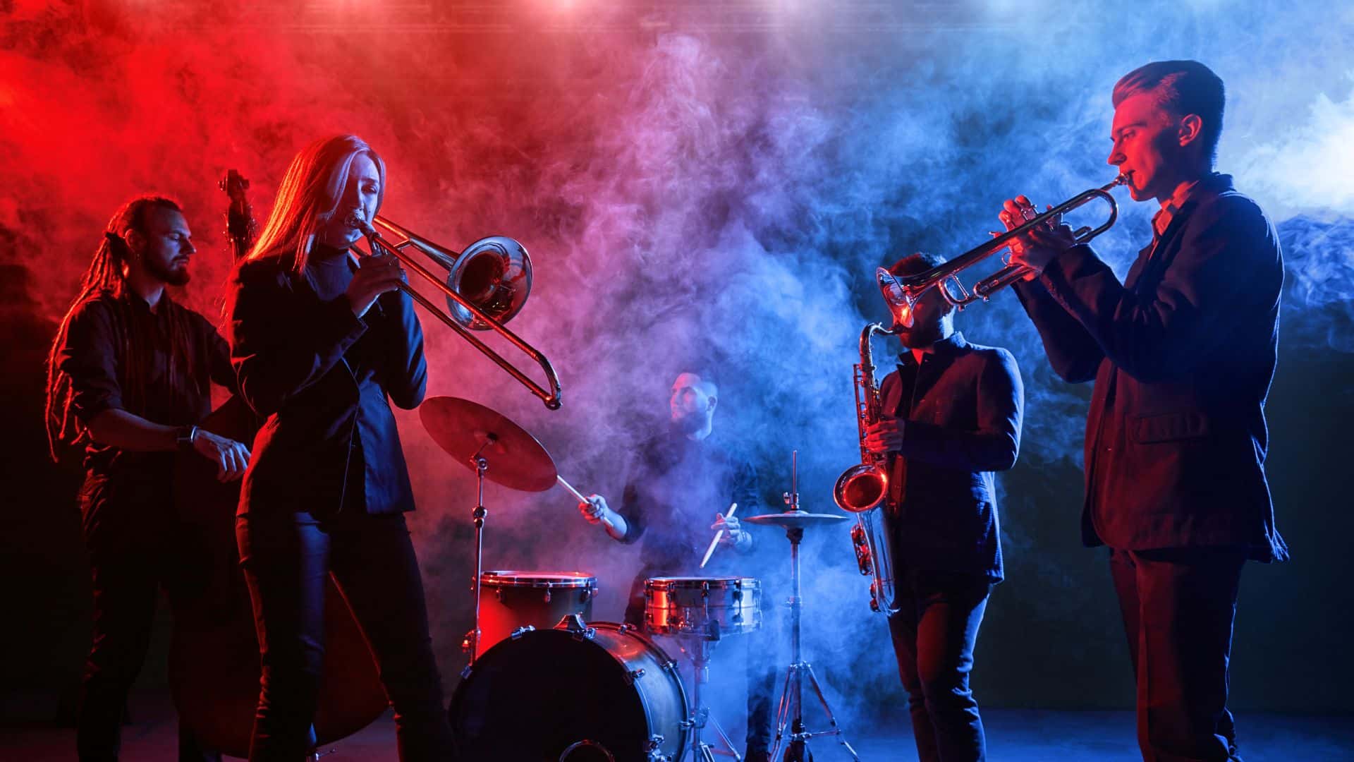 Jazz group performing on stage with smoke all around