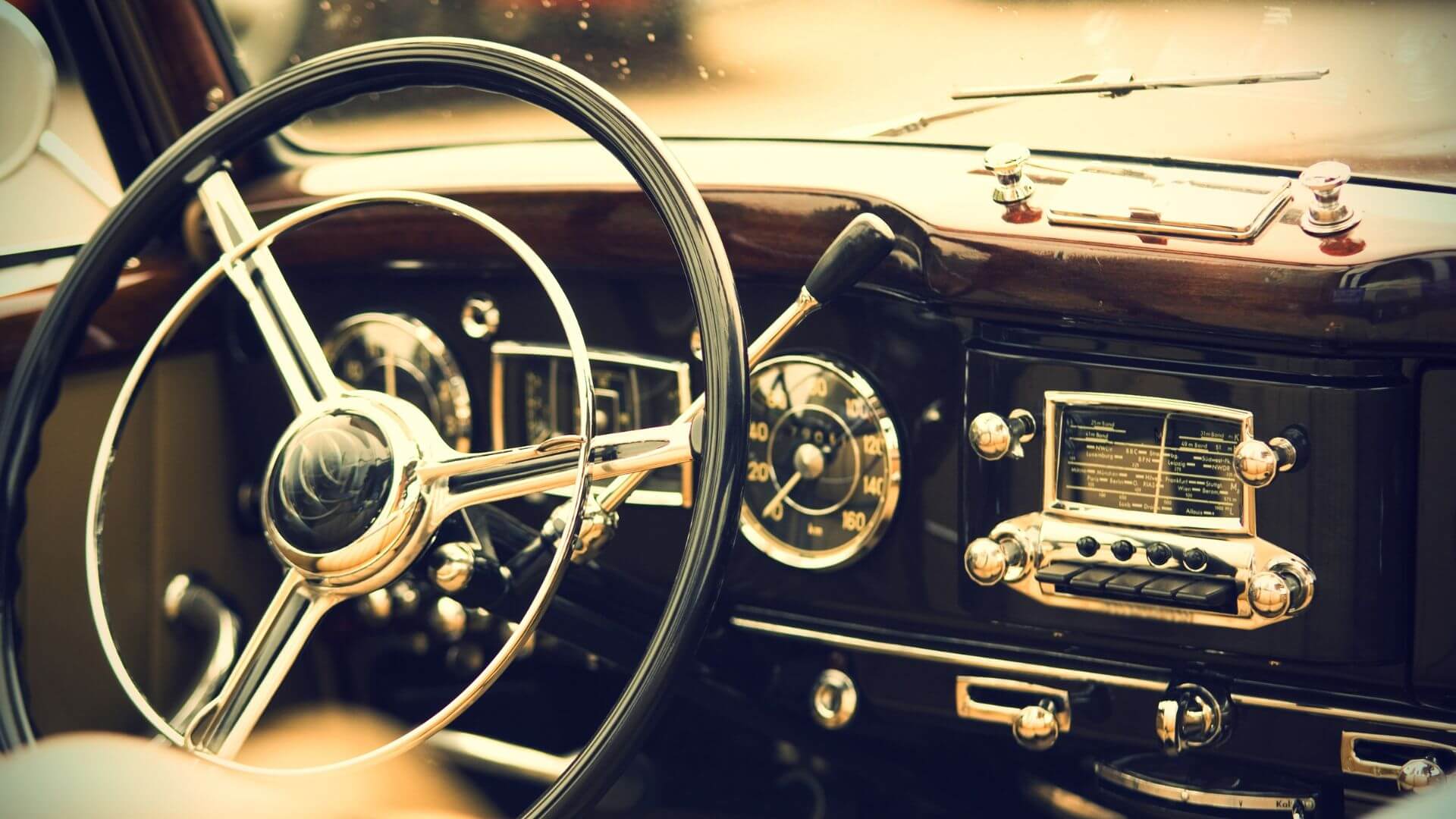 vintage car steering wheel and dashboard