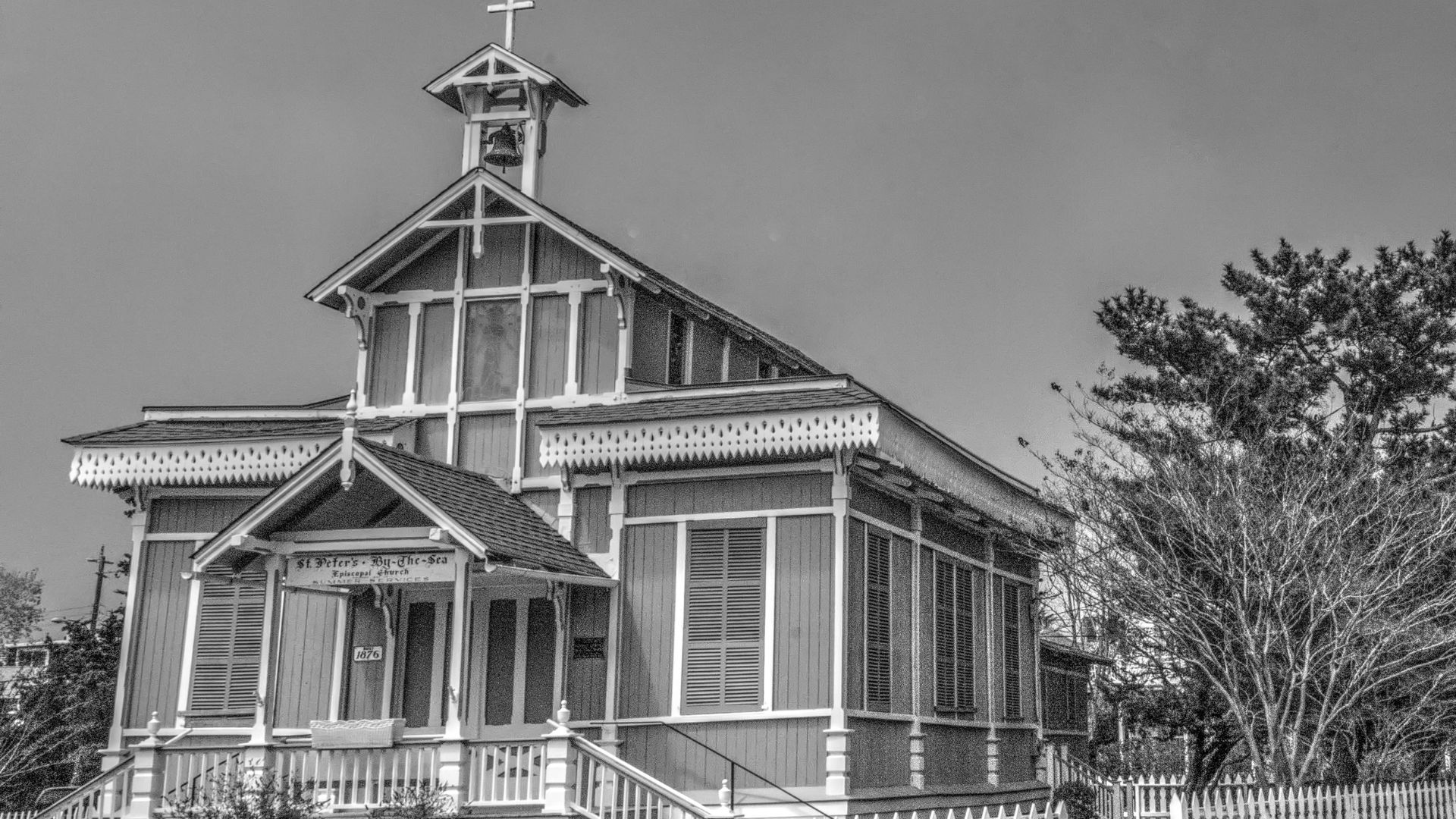Black and white photo of historic Episcopal Church facing the sea.