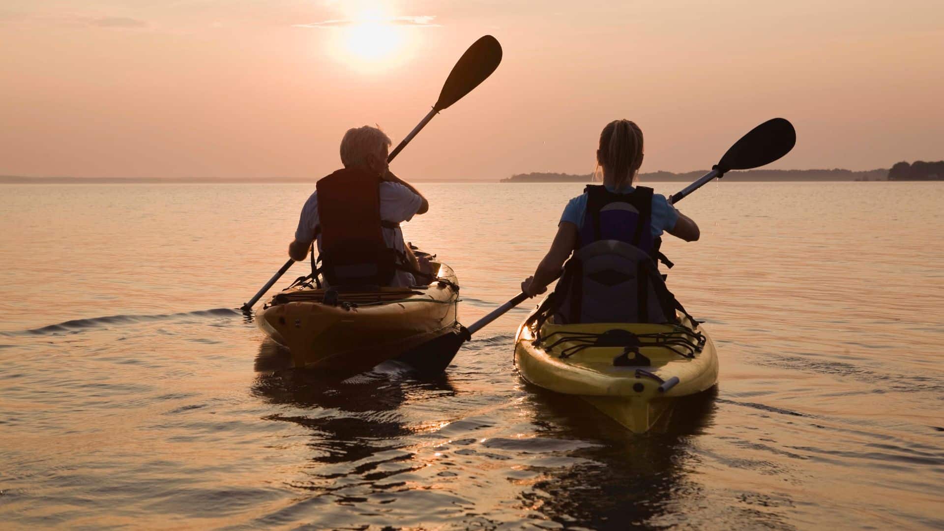 Couple kayaking at sunset