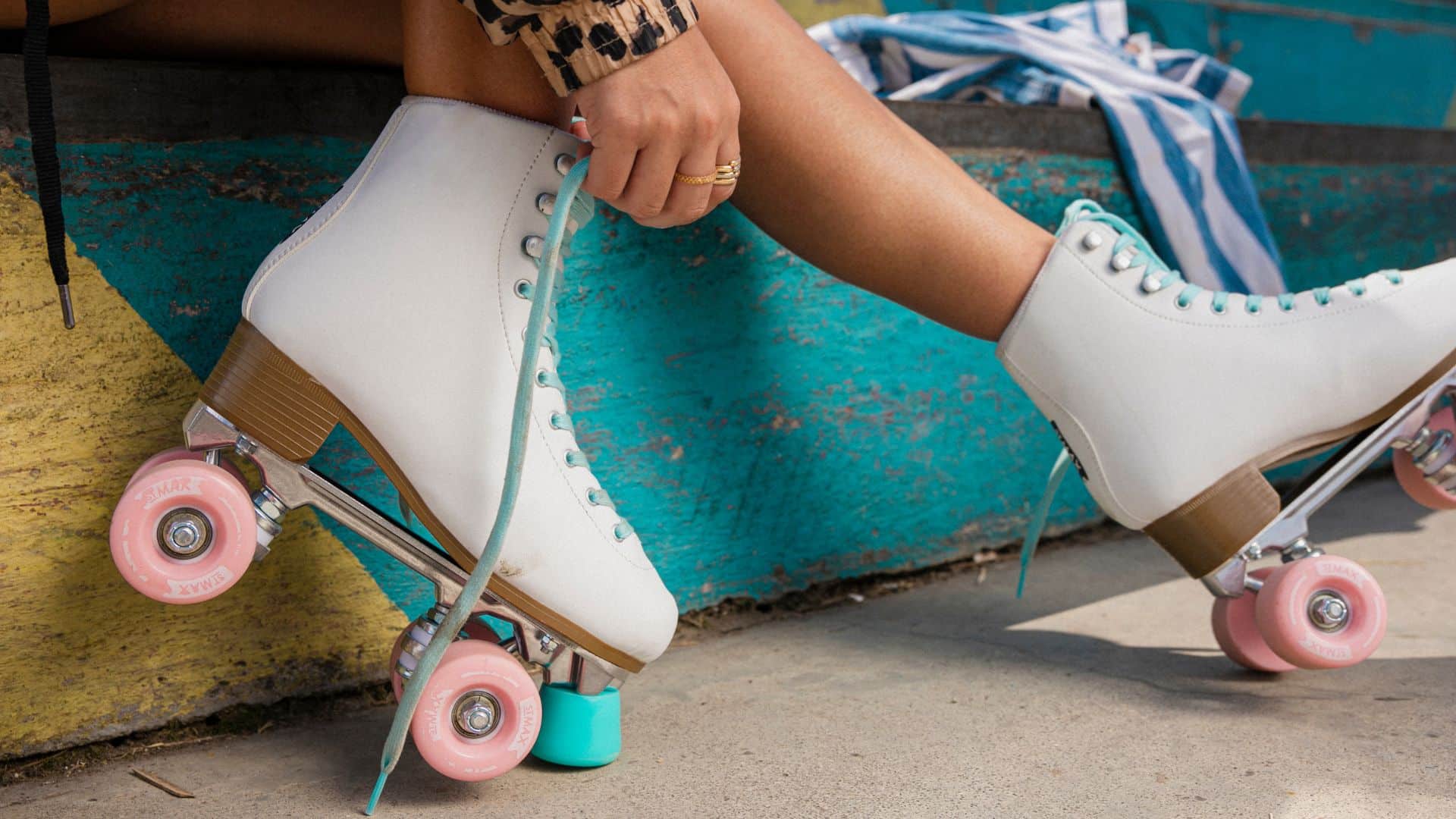 A woman putting on roller skates