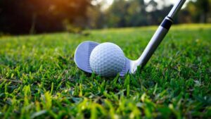 putter behind a golf ball