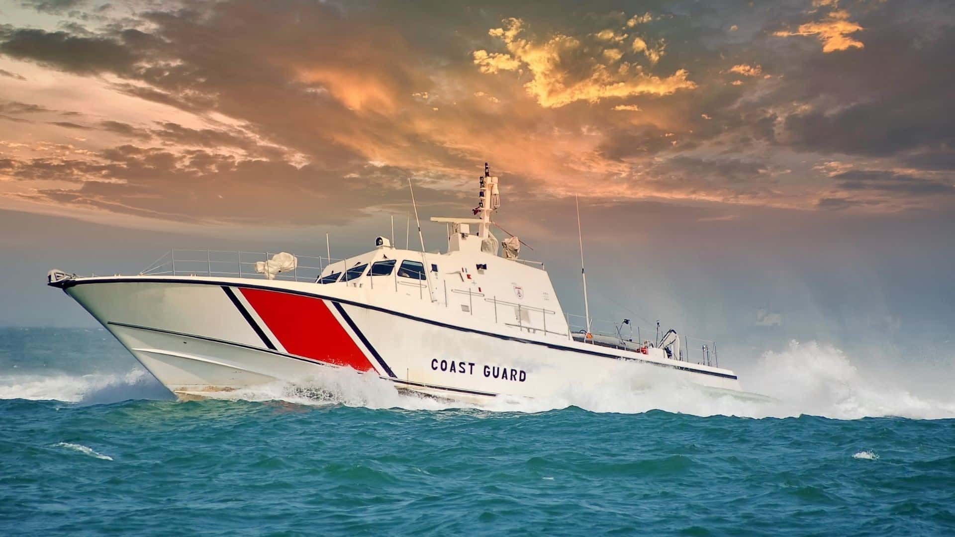 US Coast Guard vessel out at sea at sunset