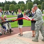 four Veterans in uniform stand folding the red, white, and blue American flag