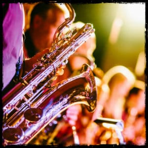 lineup of saxophone players in a live venue - image by jens thekkeveettil on www.unsplash.com