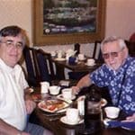 Two men sitting together over a meal