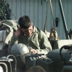 Photo of a soldier sitting in a Jeep