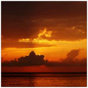 Beautiful red, yellow, and orange sunset sky over water - image by steles kazazis unsplash.com